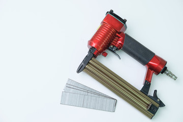 Close up pneumatic nailer gun on white background.
