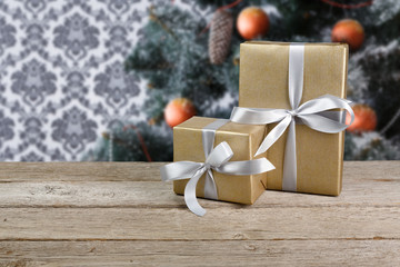 Christmas gifts on decorated tree background, holiday concept