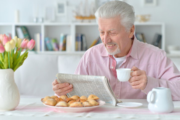 senior man reading newspaper