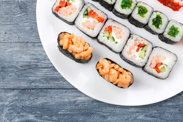 Colorful set of sushi and rolls top view on wood, closeup