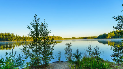 View of the lake from the shore at sunrise. Morning mist. Haukivesi lake, Saimaa lake system, Savo, Finland.