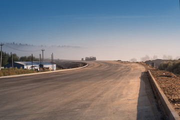 Bright sunrise over countryside empty road