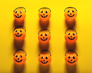 Halloween pumpkin decorations on a yellow-orange background