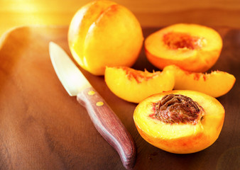 Ripe juicy Nectarines organic fruits whole and slice on wooden background. Selective focus. Toned photo.