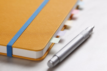 Yellow diary with pen