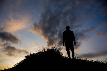 Fototapeta premium silhouette man on hill with sky for background