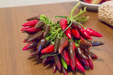bunch of chillies on wooden kitchen table