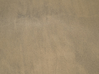 Fototapeta na wymiar Sand texture on beach as background in summer. Sand pattern.