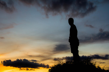 silhouette man on hill with sky for background