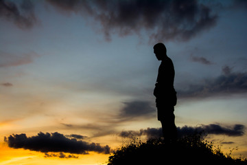 silhouette man on hill with sky for background