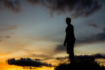silhouette man on hill with sky for background