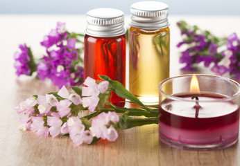 Fototapeta na wymiar Essential oils, flowers and candle.Spa concept