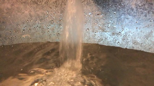Water flowing to zinc bucket and making plenty of bubbles