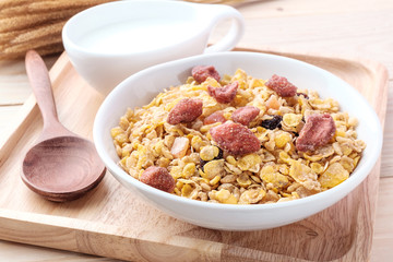 cornflakes and dry fruits on wooden background
