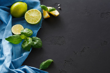 Lime and lemon with mint on black background