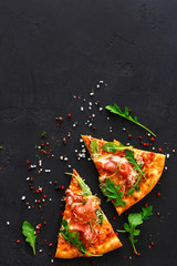 Pizza with prosciutto and rocket salad copy space - obrazy, fototapety, plakaty