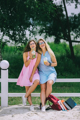 Obraz premium Two beautiful, funny girls, drinking juice