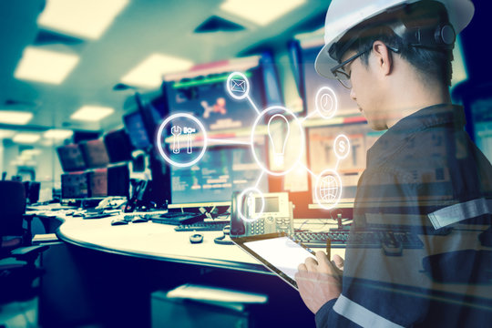 Double exposure of Engineer or Technician man with business industrial tool icons while using tablet with monitor of computers room  for oil and gas industrial business concept