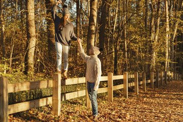Fototapeta premium Young couple in the park at sunny autumn day