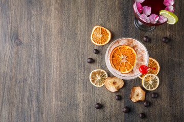 Colorful cocktails over rustic wood background