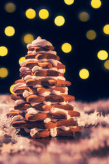Christmas gingerbread tree with lights on background