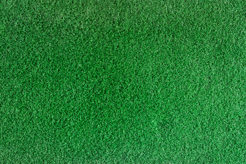 Closeup texture of golf green made of artificial grass. Putting green is a part of golf course, top view for use background.