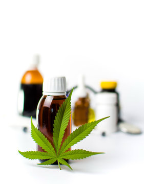 Marijuana leaf and cannabis oil bottles isolated