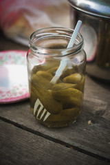 pickles in jar on the wooden table