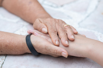 Old and young holding hands, Care for the elderly concept