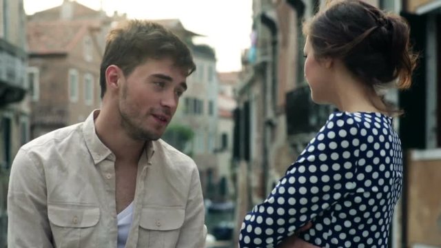 Boy and girl talking on the streets of Venice