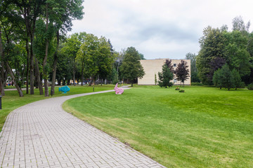 a green lawn with large trees