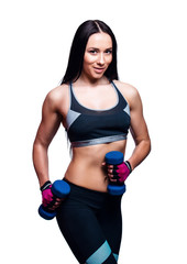 Beautiful young woman do exercises with dumbbells in studio. Sporty athletic girl lifting up weights against white background.