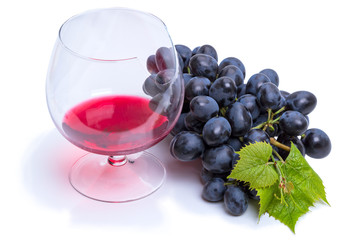 Glass of wine and a brush of dark grapes