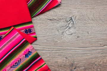Multicolor pattern cloth on wooden table for background. Fabric texture. Wooden texture.Template for designers