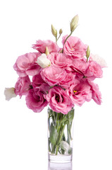 bunch of white and pink eustoma flowers in glass vase isolated on white