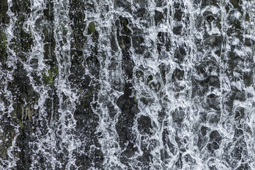 Fototapeta premium pattern of flowing water at a waterfall gives a harmonic background