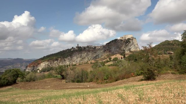 timelapse shot of view of medieval village on rock spur in Italy