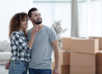 Happy couple standing in new living room