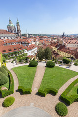 Naklejka premium View of the Vrtba Garden (Vrtbovská zahrada), St. Nicholas Church and other old buildings at the Mala Strana District (Lesser Town) in Prague, Czech Republic on a sunny day.