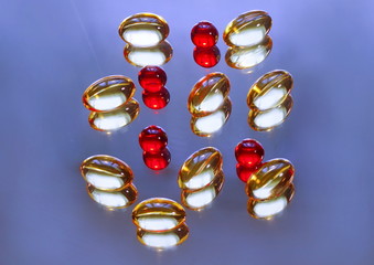 Capsules of red and yellow color. Vitamins and preparations for health promotion.