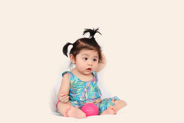 Asian cute baby girl in swimming suit sitting