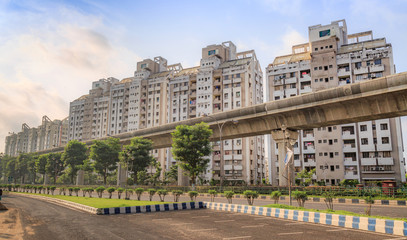 Fototapeta na wymiar Tall city residential buildings with under construction over bridge at Kolkata, India.