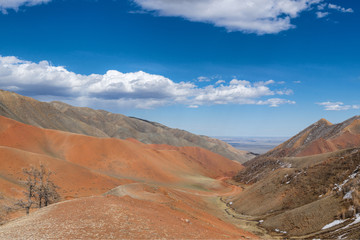 picturesque view of road between of snow-covered mountain terrain 
