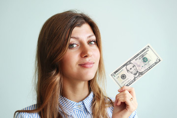 Smile woman with five dollar on a blue background