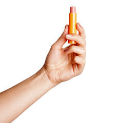 Woman holding pink lipstick in her hand. 