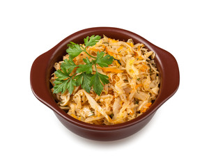 Stewed cabbage meal in clay bowl, isolated on white