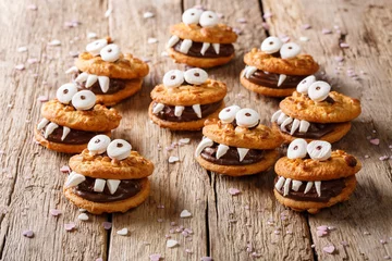 Zelfklevend Fotobehang Halloween Dessert: funny monsters from cookies close-up. horizontal  © FomaA