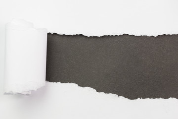 white paper torn outside black paper 