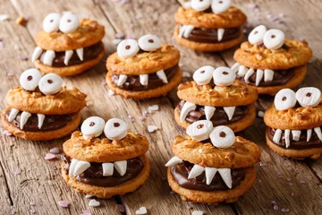Schilderijen op glas Toothed monsters of cookies close-up for Halloween. horizontal © FomaA