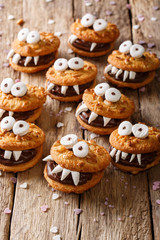 Peanuts chocolate cookies monsters close-up on a table for Halloween. vertical